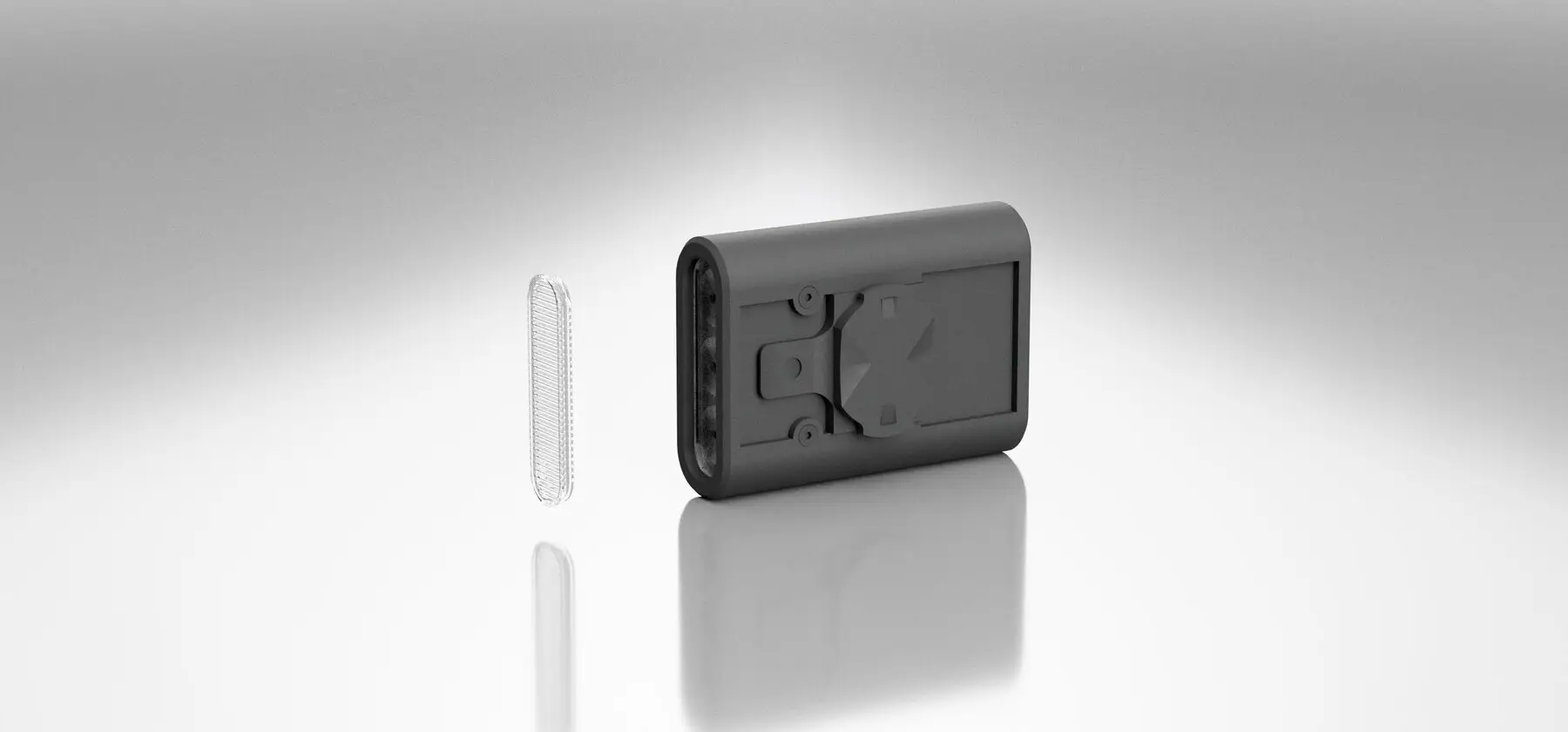 The BYB Focus StVZO lens lying beside the light body, which is turned to show its mounting face.