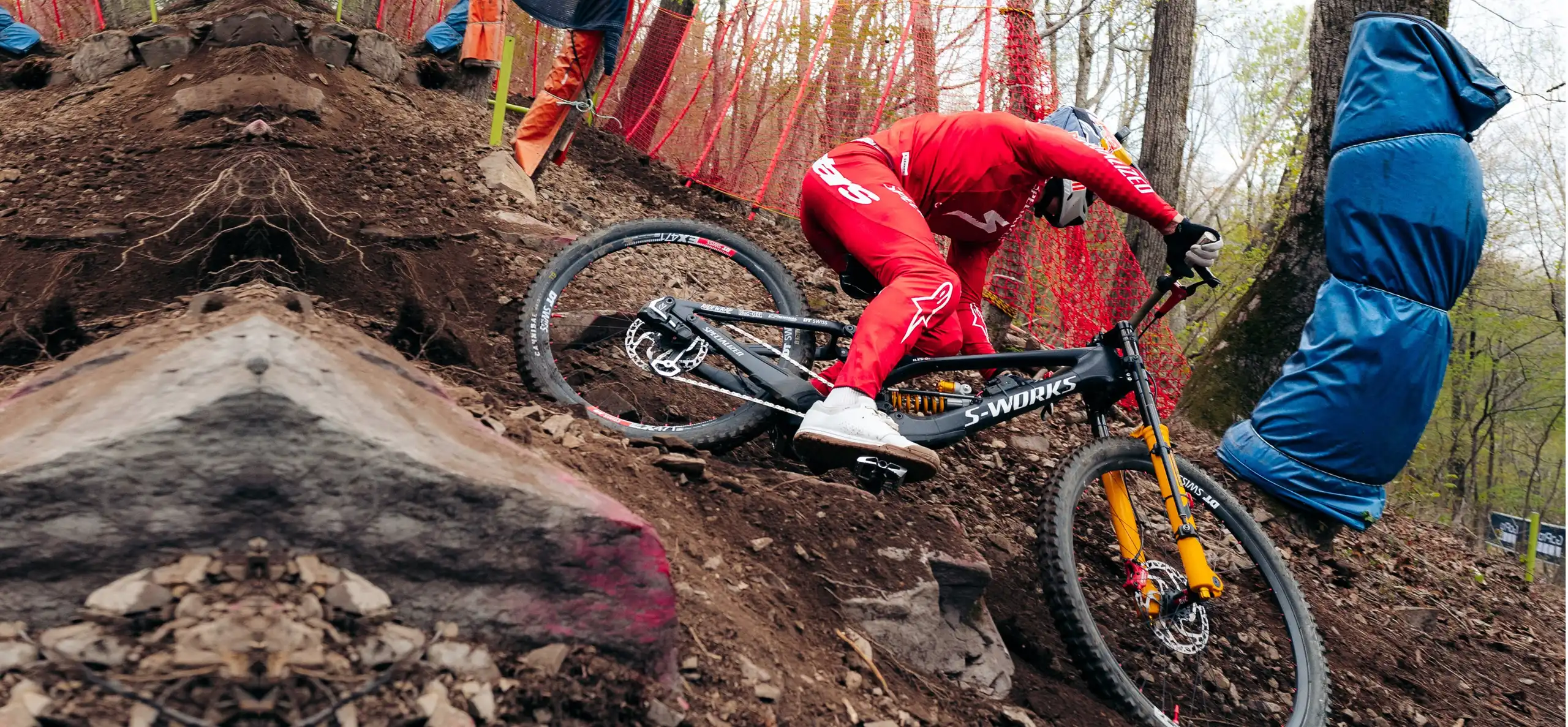 Finn Iles racing a Specialized downhill bike at the UCI Downhill World Cup in South Korea, with a BYB Telemetry suspension sensor on the fork and the acquisition unit on the frame.